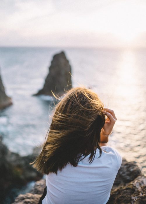 woman overlooking oceanside cliff